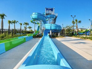 A water park with multiple slides and a pool.