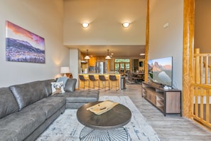 Relax in a cozy living space with a comfortable sofa, flat-screen TV, and kitchen area.