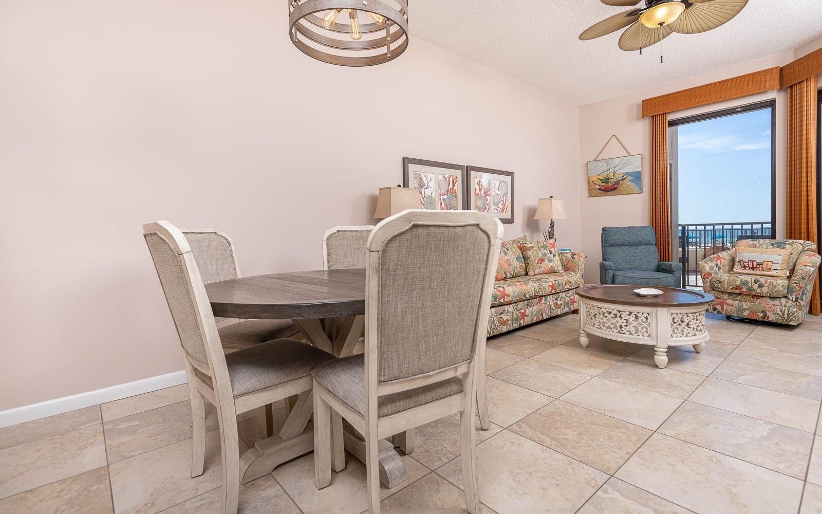 A dining area with a round table and chairs, a sofa, and a coffee table.