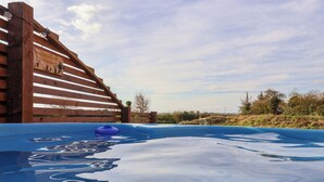 A swimming pool with a wooden deck and a sign. - Mischief (Driffield)