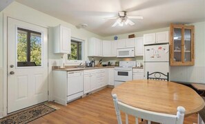 Enjoy cooking in this well-equipped kitchen with a microwave, refrigerator, and stove.