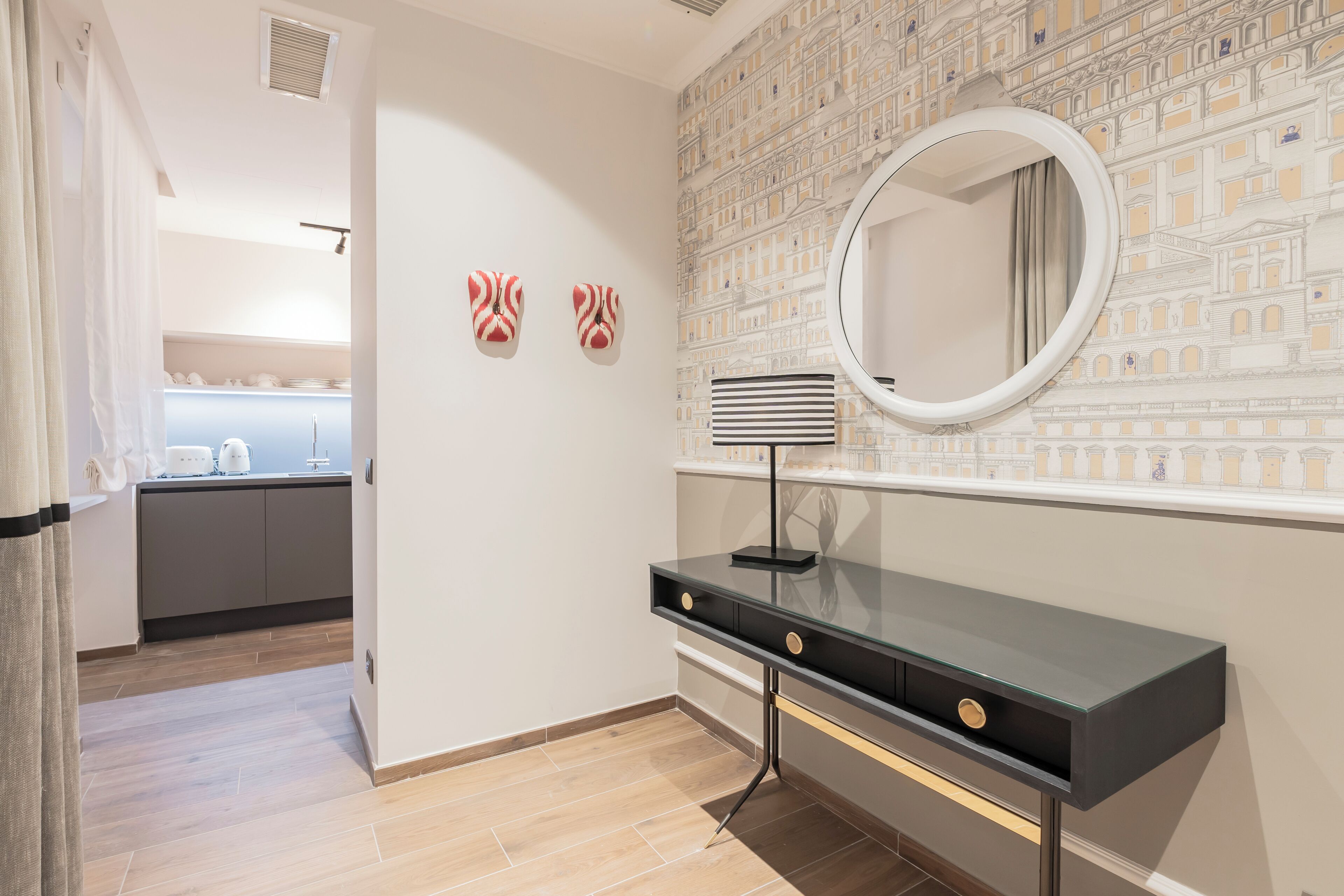 A modern bathroom with a vanity, a mirror, and a patterned wall.