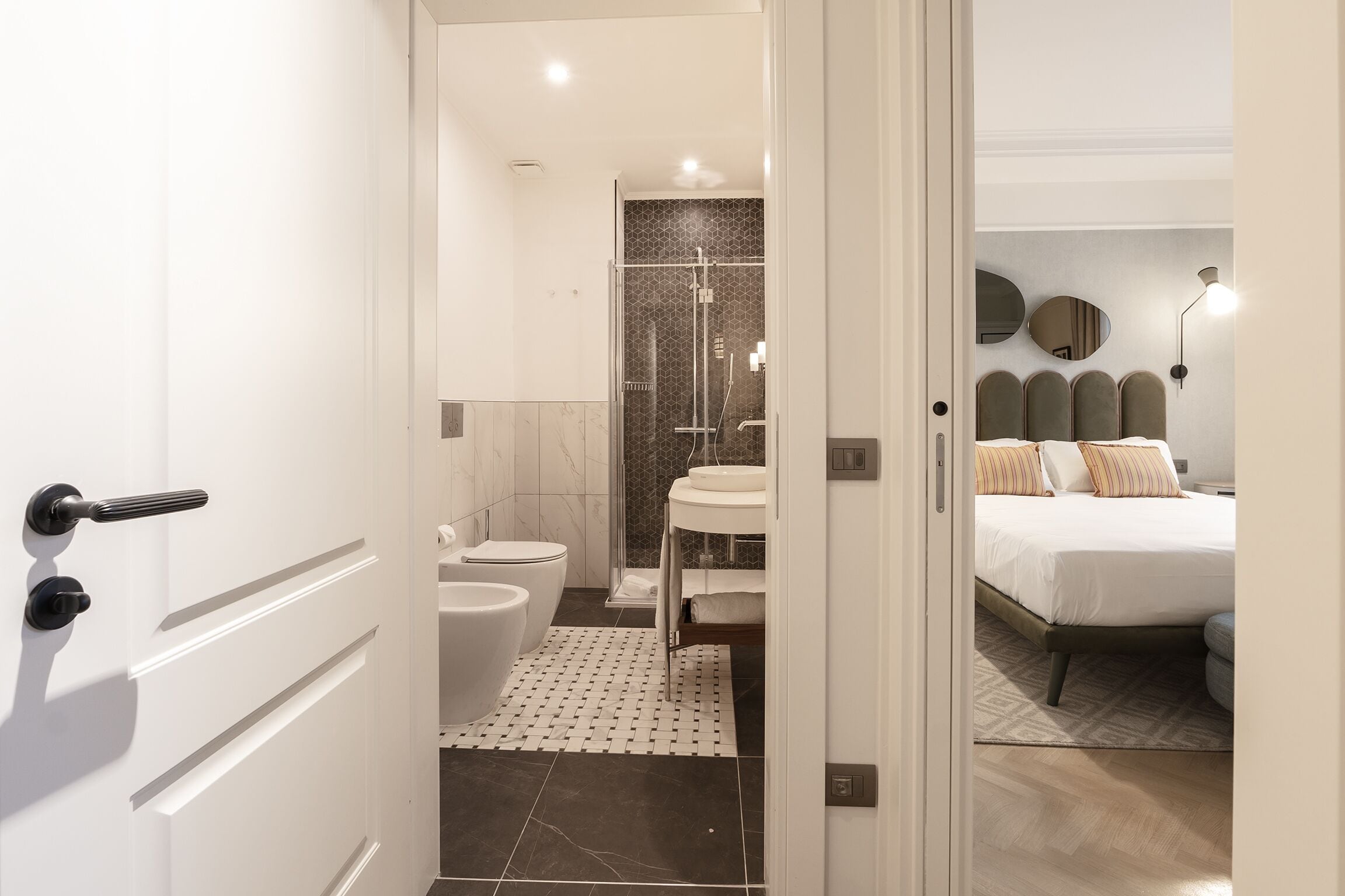 A modern bathroom with a shower, toilet, and sink.