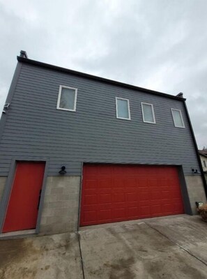 Two-story building with a garage and driveway.
