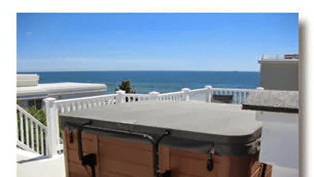 A suitcase on a balcony with a view of the ocean. - One off the Ocean with incredible views (North Beach)