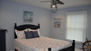 A bedroom with a bed, a ceiling fan, a window with blinds, and two paintings on the wall. - 5 bedroom accommodation in Loveladies (Loveladies)