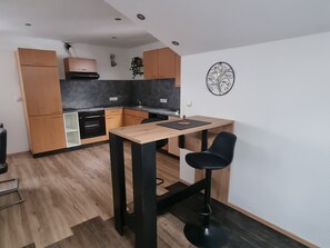 Fridge, stovetop, dishwasher, coffee/tea maker