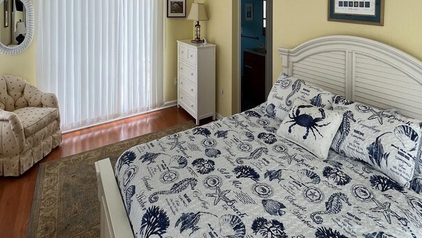 A bedroom with a bed, a chair, a dresser, a ceiling fan, and a window with blinds. - Amazing home in Beach Haven with 4 Bedrooms, Internet and WiFi (Beach Haven)