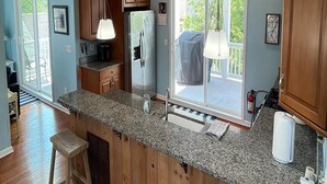 A kitchen with wooden cabinets, granite countertops, a stainless steel refrigerator, and pendant lighting. - Amazing home in Beach Haven with 4 Bedrooms, Internet and WiFi (Beach Haven)