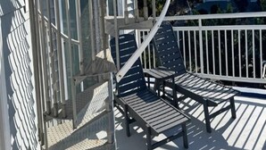 A spiral staircase leading to a balcony with outdoor seating. - 5 BRs, Hot Tub Roof Top, 2nd off the Ocean. (Loveladies)