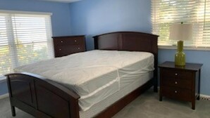 A bedroom with a bed, dresser, nightstand, and window with blinds. - Short walk to Ocean-great for large family (Beach Haven Terrace)