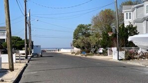 A quiet street with houses, a sidewalk, and utility poles. - Short walk to Ocean-great for large family (Beach Haven Terrace)