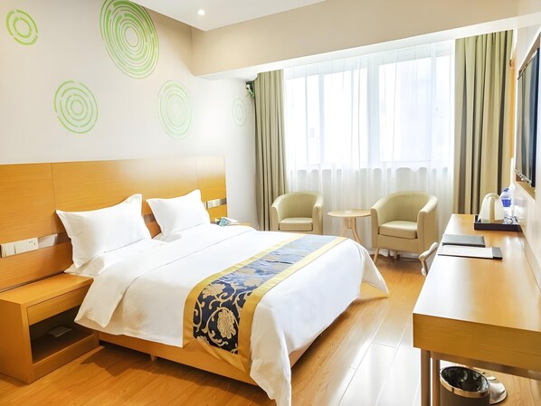A hotel room with a bed, bedside tables, a desk, two chairs, a TV, and a window with curtains. - Greentree Inn Xi an Ming City Wall Northwest Dafengqing Road Business Hotel (Xi'an)