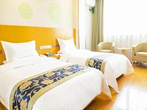 A hotel room with two beds, a headboard, a nightstand, a chair, a small table, and a window with curtains. - Greentree Inn Xi an Ming City Wall Northwest Dafengqing Road Business Hotel (Xi'an)