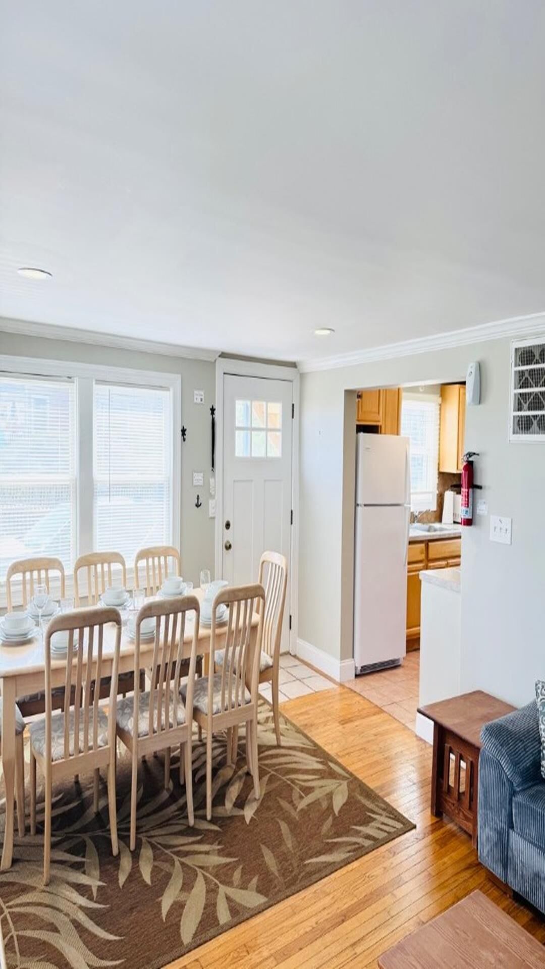 A compact living space with a dining area, kitchen, and a small seating area.