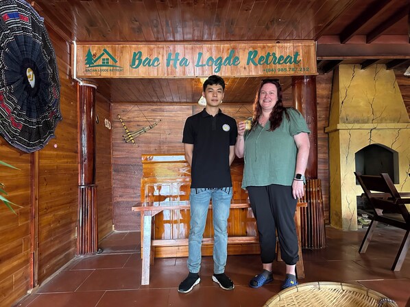 A wooden interior with a sign reading "Bac Ha Logde Retreat" and a contact number. - Bac Ha Lodge Reatreat (Bac Ha)