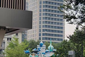 A building with a modern design, a large windowed facade, and a decorative structure with blue and white elements in the foreground. - Xin'anjiang Hotel (Jiande)