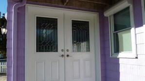 A white double door with glass panels and a window to the right. - Oceanside 3 Bedroom, 1 Bath Duplex - A Short Walk to the Beach! (Beach Haven Crest)
