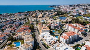 Vista aérea de una zona residencial costera con edificios, carreteras y una gran masa de agua.