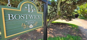A wooden sign with the name 'BOSTWICK'S' and the words 'MAGNOLIA MANOR' on it. - Bostwick's Magnolia Manor (Wanchese)