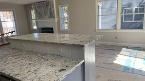A kitchen with granite countertops, a built-in oven, and a window overlooking the backyard. - 5 bedroom accommodation in Long Beach Township (Long Beach Township)
