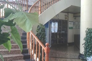 A staircase with wooden handrails leading to a landing.