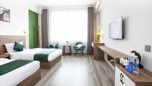 A hotel room with two beds, a desk, a chair, a TV, and a window with curtains. - Pu'er Kunman Hotel (Pu'er)
