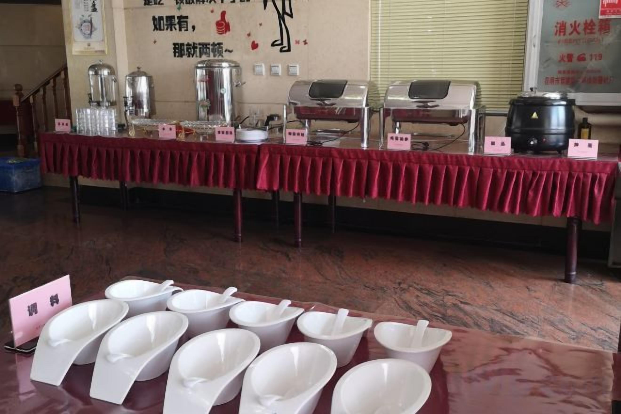 A buffet setup with multiple serving stations, including a coffee machine and a rice cooker.