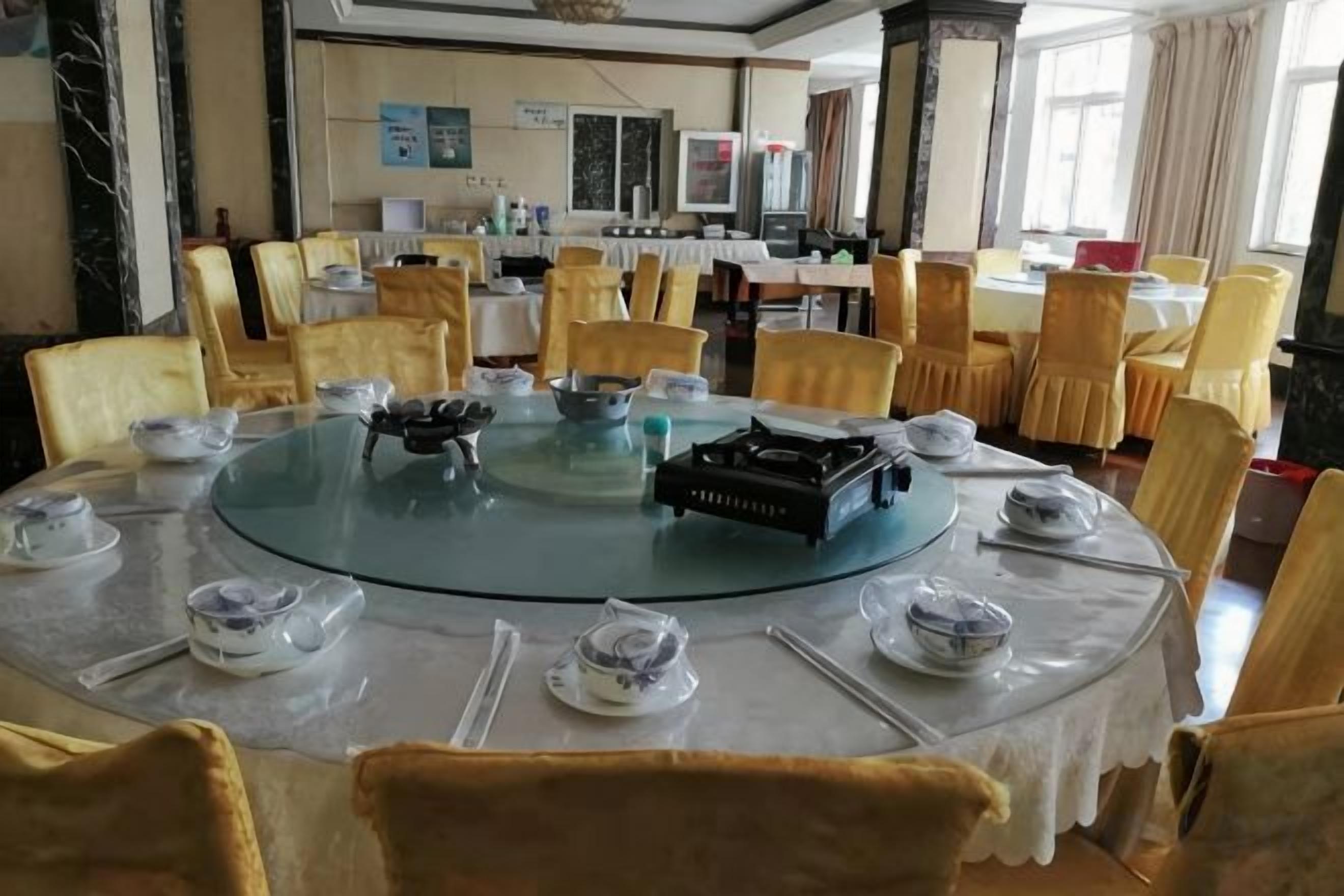A conference room with a round table, chairs, and a projector.