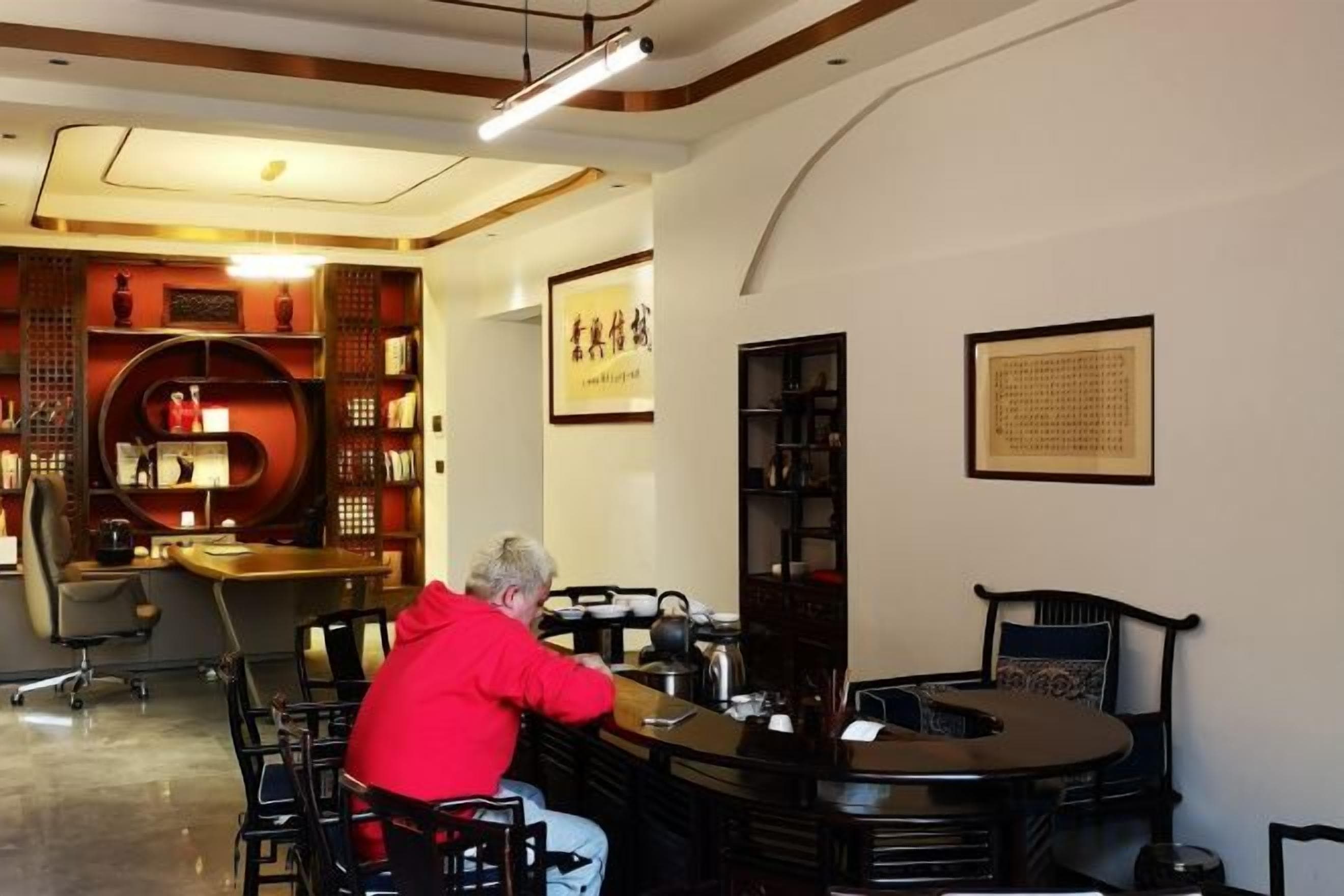 A hotel lobby with a reception desk, seating area, and traditional decor.