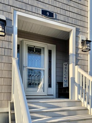 A house with a number 9 sign, a white door with a glass panel, and a 'WELCOME' sign on the wall. - Ocean views- luxurious vacation rental on LBI (Brant Beach)
