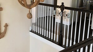 A chandelier, a staircase, and a kitchen area. - Ocean views- luxurious vacation rental on LBI (Brant Beach)