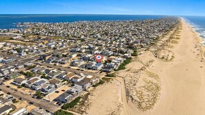 An aerial view of a coastal residential area with houses, a beach, and a marina. - Nice home in Ship Bottom with 3 Bedrooms, Private swimming pool and WiFi (Ship Bottom)