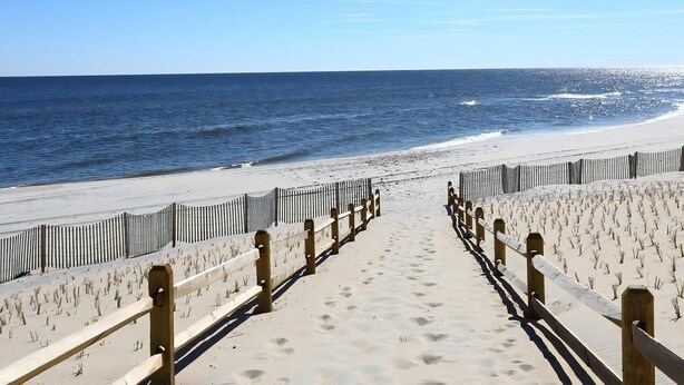 A beach pathway leading to the ocean with a wooden railing. - North Beach Townhouse (North Beach)
