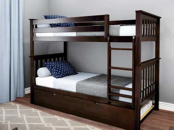 A bunk bed with a lower bunk, a mattress, pillows, and a blanket. - pet friendly vacation rental on LBI (Brant Beach)