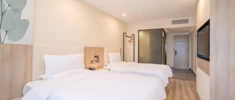 A modern hotel room with two beds, a wooden headboard, a bedside table, a wall-mounted TV, and a large window.