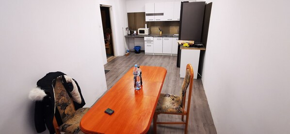 A compact kitchen with white cabinets, a microwave, and a small countertop. - Hostel Warszawa Powstaniec (Warsaw)