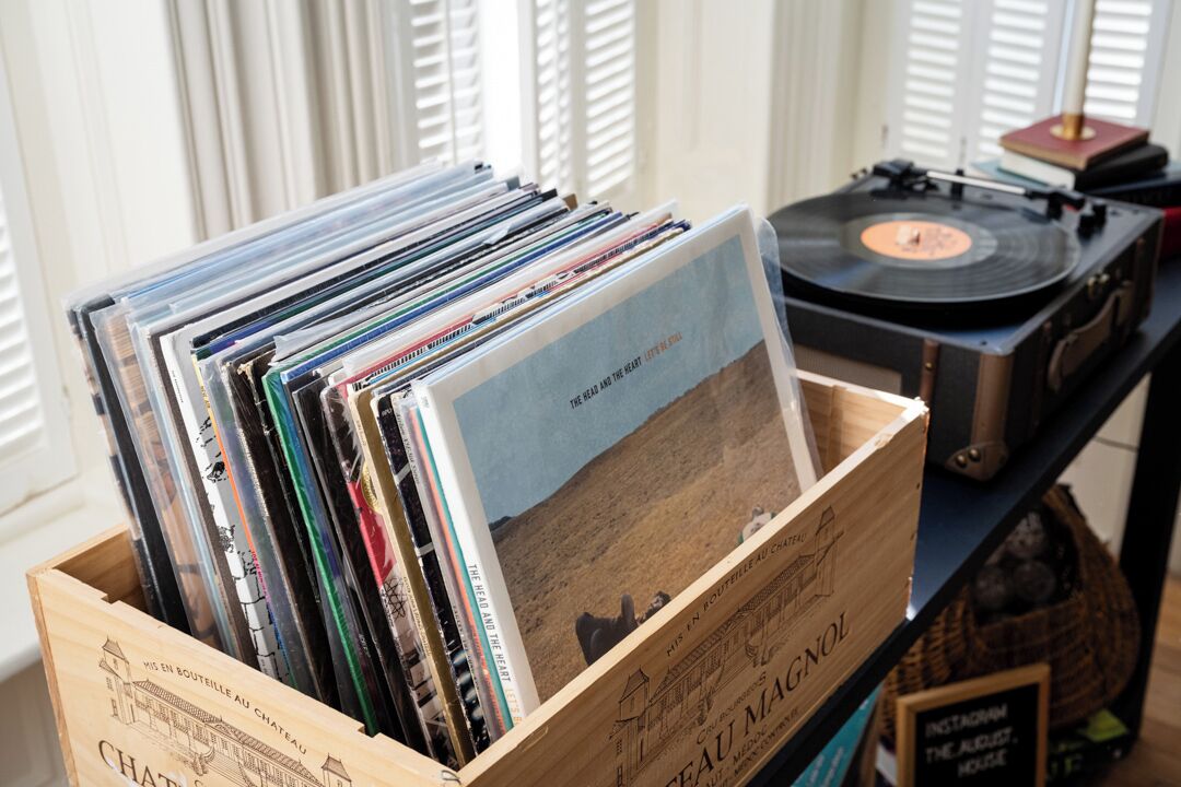 Una caja de madera llena de discos de vinilo y un tocadiscos.