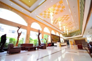 A spacious lobby with a high ceiling, large windows, and a reception desk. - Tianzi Lake Ecological Resort (Xiaogan)