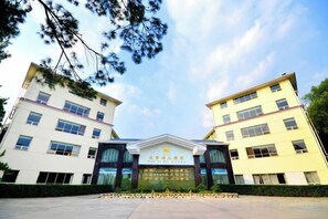 A building with a symmetrical facade, large windows, and a central entrance with a sign. - Tianzi Lake Ecological Resort (Xiaogan)