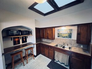 Fridge, microwave, coffee/tea maker, cookware/dishes/utensils