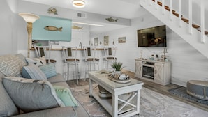 A modern living room with a sofa, chairs, a coffee table, and a TV. - 🌊 Gulf Views~Prime Spot~Pet Friendly~Steps to Beach~Vacay with a View 🌊 (Miramar Beach)