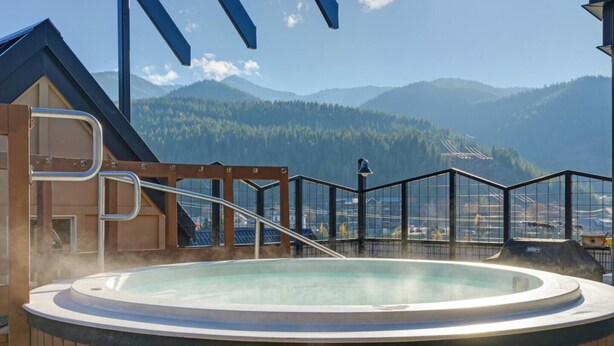 A hot tub on a deck with a mountain view. - The Silver Valley Slope - Resort and Hot Tub (Kellogg)