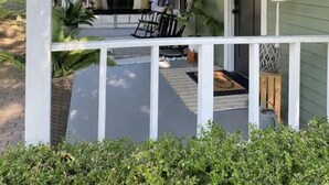 A porch with a white railing, a bench, and potted plants. - The Flat on 5th-walk to dt! (Coeur d'Alene)