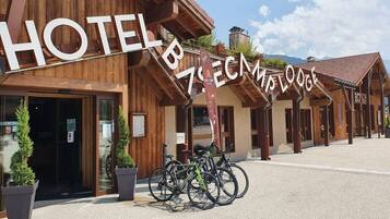 Un hotel de arquitectura de madera, un cartel y bicicletas estacionadas al frente.