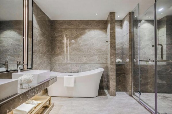 A modern bathroom with a freestanding bathtub, two sinks, and a glass shower enclosure. - Joy Hotel Hangzhou (Hangzhou)