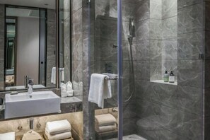 A modern bathroom with a glass-enclosed shower, a large mirror, and a white sink. - Joy Hotel Hangzhou (Hangzhou)