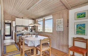 Enjoy meals in this kitchen with a dining area for two, featuring a table and chairs.