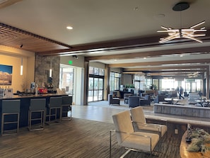 A spacious lobby with a reception desk, seating area, and large windows. - Grand Colorado, 3 BD, master & 2 suites. Luxury Resort, steps to lifts & gondola (Breckenridge)