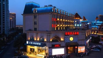 A multi-story hotel with a prominent entrance and signage.